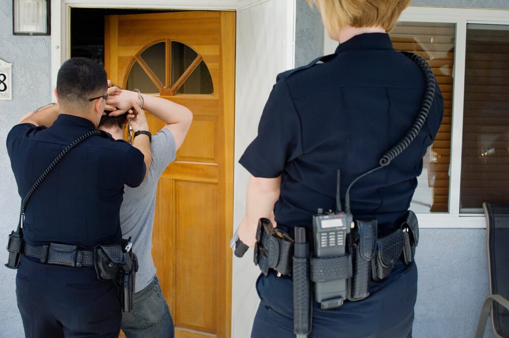 Police officer arresting a man