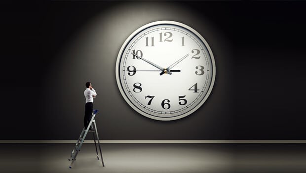 Man in the ladder looking at the clock